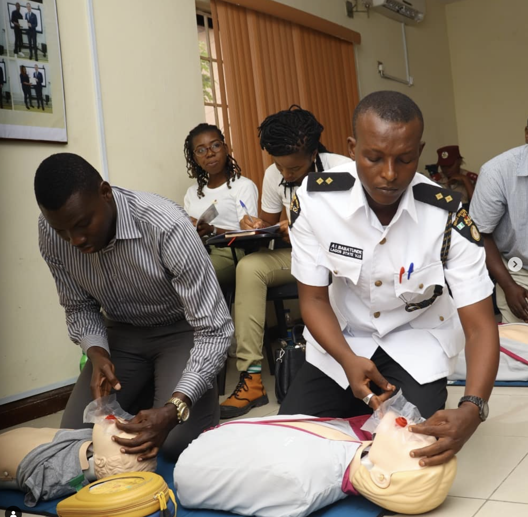 Image shows Health Emergency Initiative training first responders in First Aid and CPR, enhancing emergency preparedness and community health.